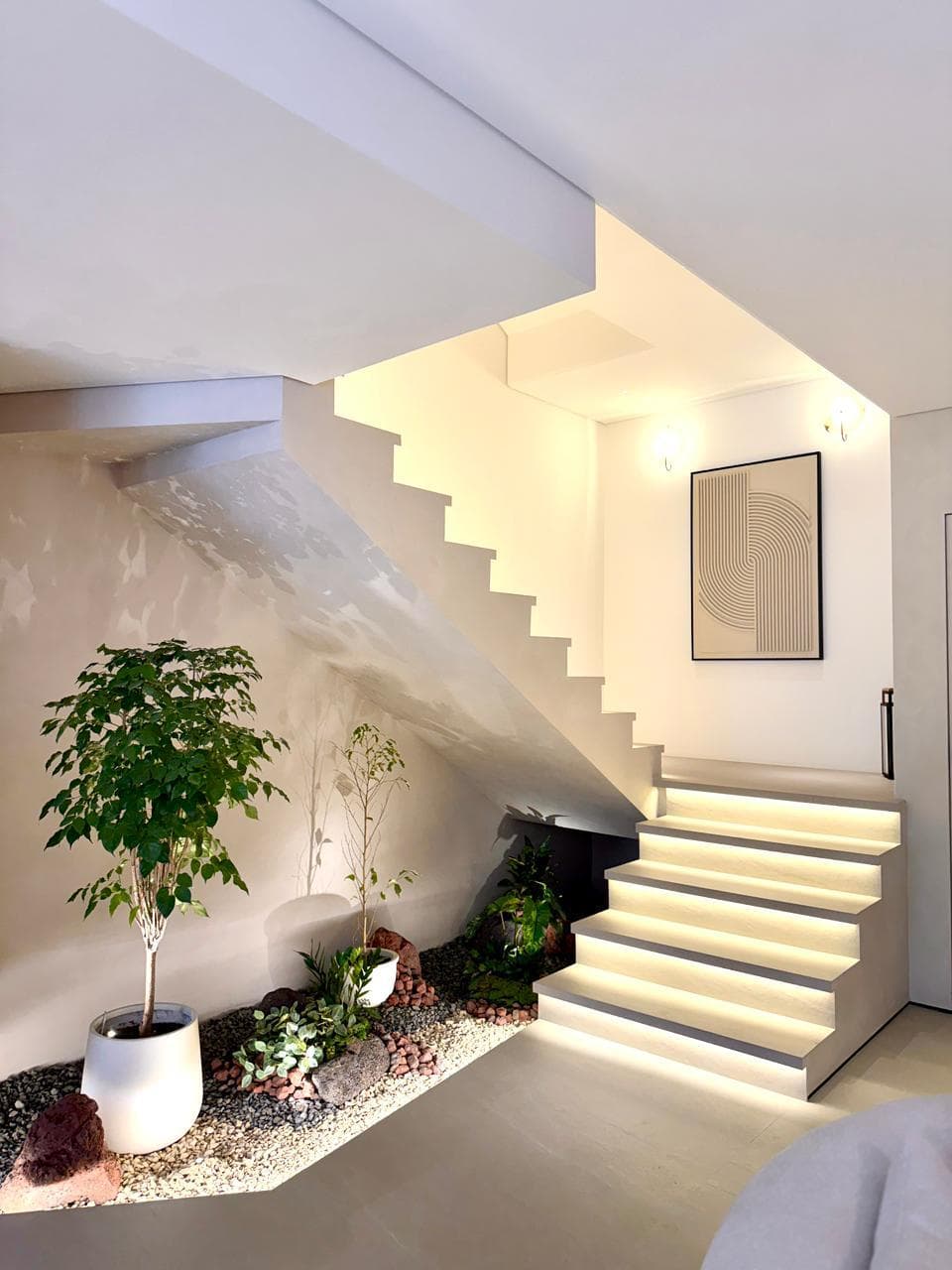 Sculptural staircase with integrated indoor garden — luxury residential renovation by Concreto Technical Services, Dubai